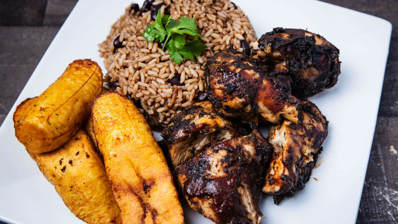 A spread of traditional Caribbean dishes on a wooden table