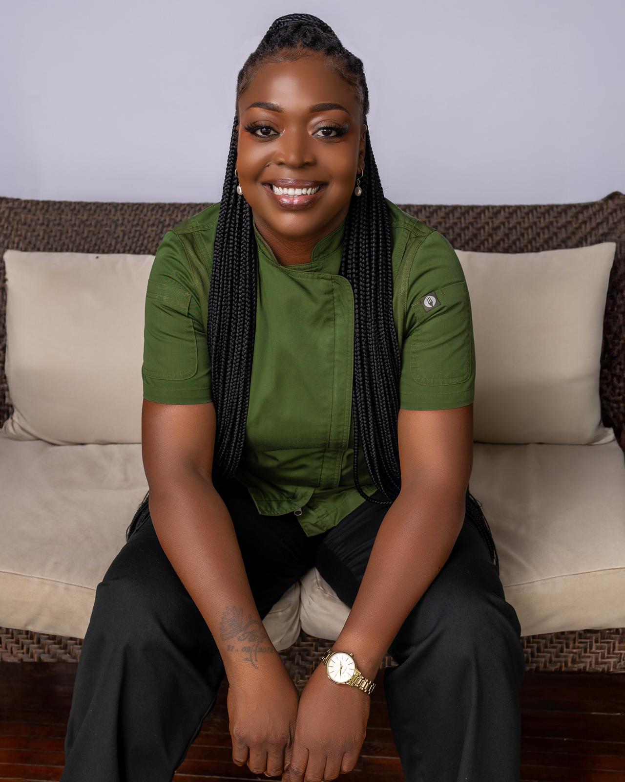 The founder seated, smiling, in a green chef's jacket